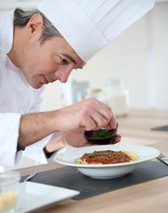 Chef in kitchen preparing italian dish