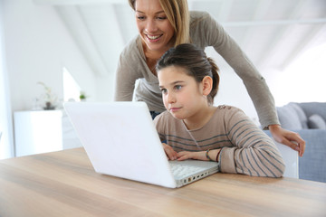 Mother and daughter calling dad through internet