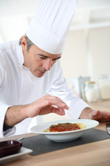 Chef in kitchen preparing italian dish