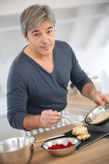 Man in home kitchen preparing pastries