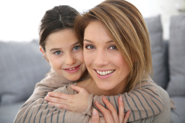 Mother with daughter relaxing at home