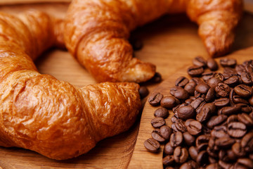Closeup of croissants and coffee beans