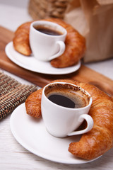 Cups of coffee with croissants