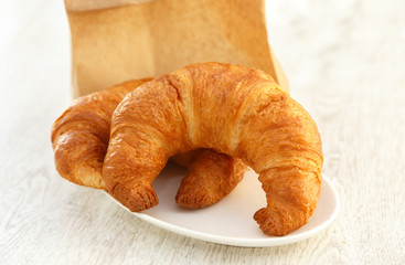 Two croissants on a little plate
