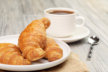 Plate with croissants and a cup of coffee