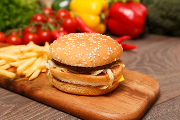 Burger and fries on a chopping board