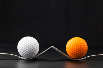 Golf balls on the black background