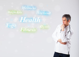 Clinical doctor pointing to health and fitness collection of wor