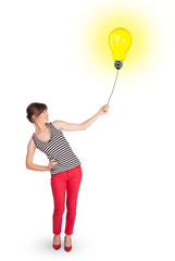 Happy woman holding a light bulb balloon