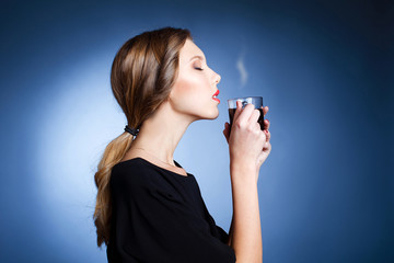 Beautiful young woman holding a coffee cup