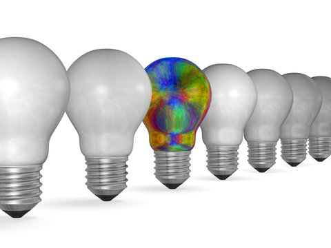 One multicolored iridescent light bulb in row of many white ones