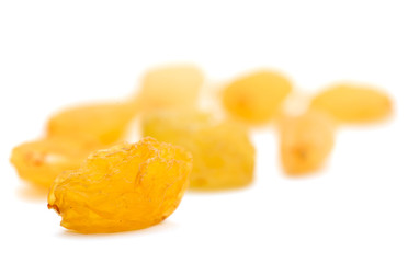 Golden raisins on a white background