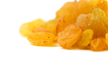 Golden raisins on a white background