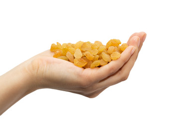 Fototapeta premium golden raisins in hand on white background