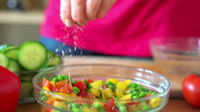 Sprinkle seasonings on fresh salad, super slow motion,