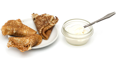 fried pancake with sour cream on a white background