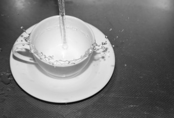 water in the cup with a spray