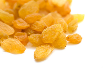 yellow raisins on a white background. macro