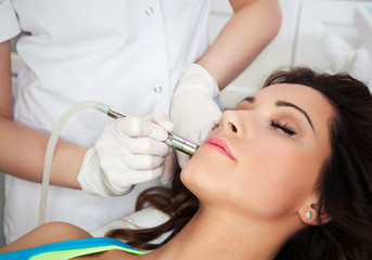 Woman getting laser face treatment in medical spa center - 61375907
