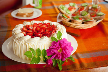 Delicious strawberry cake on coffee table