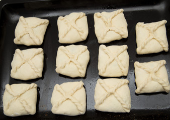 pies with meat on black pan
