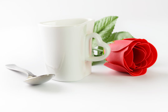 Love shape cup with tea spoon and red rose
