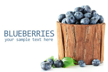 Blueberries in wooden basket isolated on white