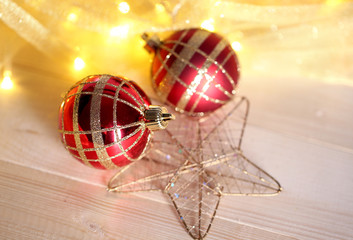 Christmas ornaments and garland on wooden table close-up