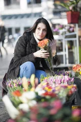 Door stickers Flower shop beautiful woman choosing flowers at the florist shop