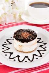 Sweet cake with chocolate on plate on table close-up