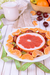 Sweet fresh fruits on plate on table close-up