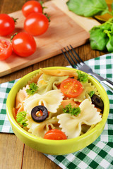 Delicious pasta with tomatoes on plate on table close-up