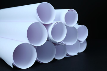 White paper rolls on black background close-up