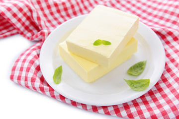 Tasty butter on plate, isolated on white