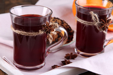 Mulled wine with cookies on table close up