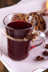 Mulled wine with cookies on table close up