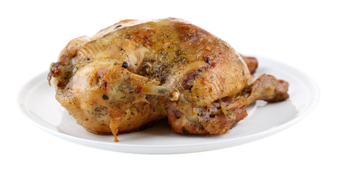 Whole roasted chicken on plate, isolated on white
