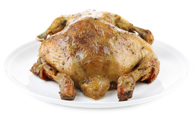 Whole roasted chicken on plate, isolated on white
