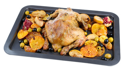 Whole roasted chicken with vegetables on tray, isolated on