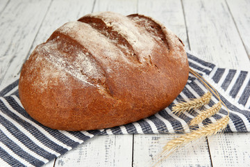 Rye bread on napkin on wooden background