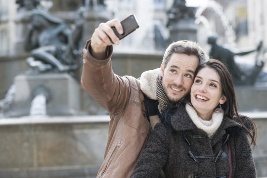 romantic couple in the city taking a selfie