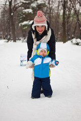 Fototapeta na wymiar Baby make first steps in the snow