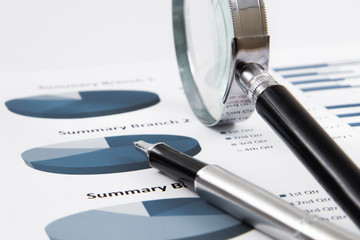 magnifying glass on the business report