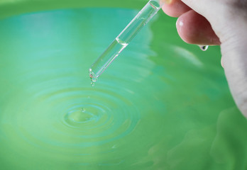 Hand with pipette.