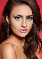 Obraz premium Beautiful passionate brunette woman on red