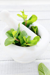green mint in white mortar