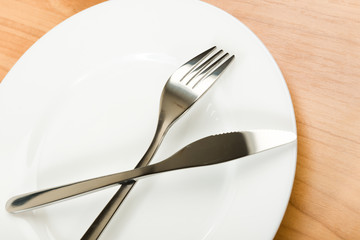 knife and fork on white plate
