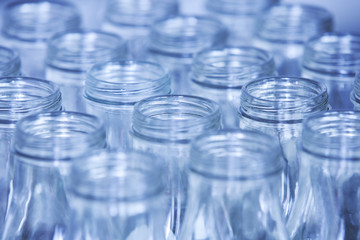Rows of glass bottles ready for recycling, shallow depth of fiel