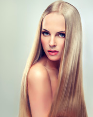 Beautiful blonde woman with long, healthy and shiny hair.