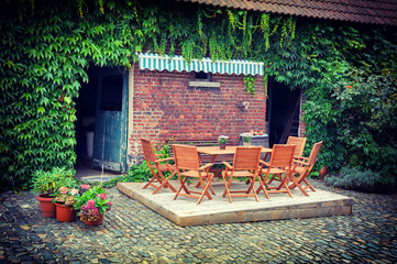 Fototapeta na wymiar Farm backyard with table and chairs